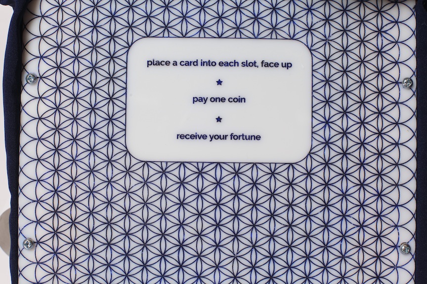 "place a card into each slot, face up /*/ pay one coin /*/ receive your fortune".